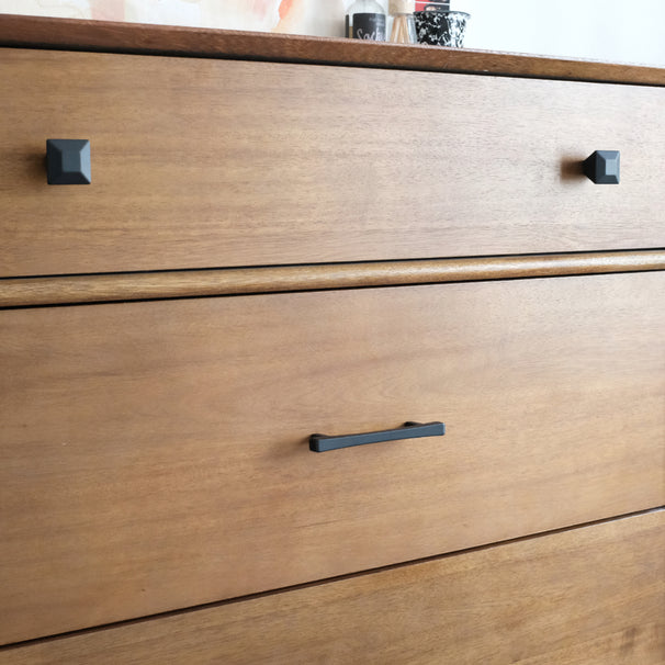 Black diamond cabinet pulls on a wood dresser with cabinet knobs