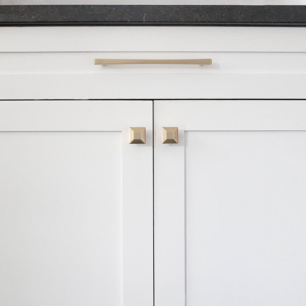 Satin brass gold diamond pulls and knobs on white cabinet