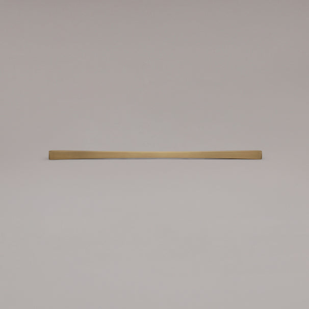 18" Diamond appliance pull in Satin Brass laying on gray background
