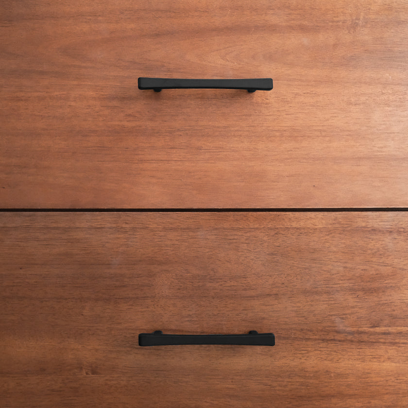 Black diamond cabinet pulls on a wood dresser