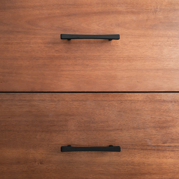 Black diamond cabinet pulls on a wood dresser