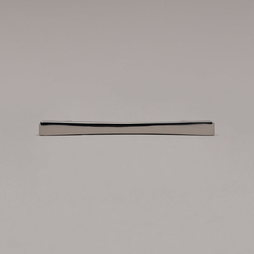 polished nickel diamond cabinet pull laying on gray background