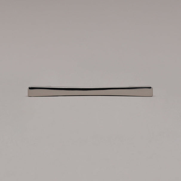 polished nickel diamond cabinet pull laying on gray background