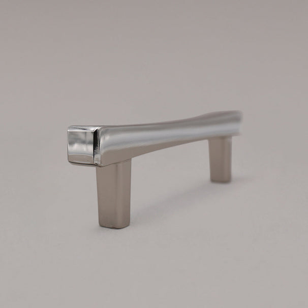 polished nickel diamond cabinet pull standing on gray background side view