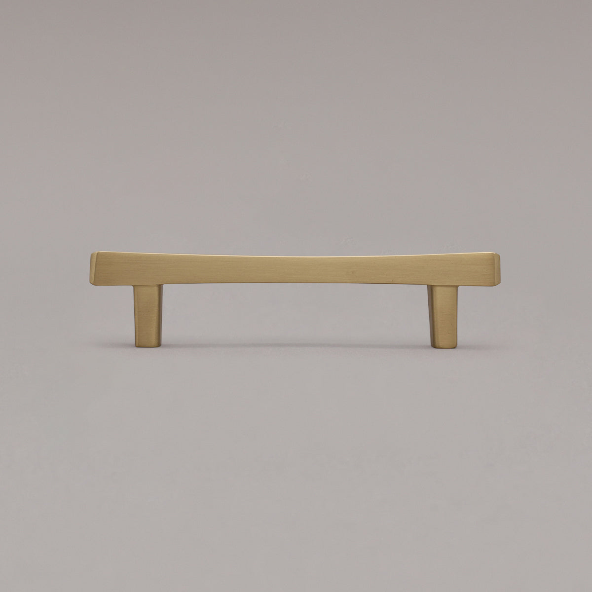 satin brass gold diamond cabinet pull standing on gray background