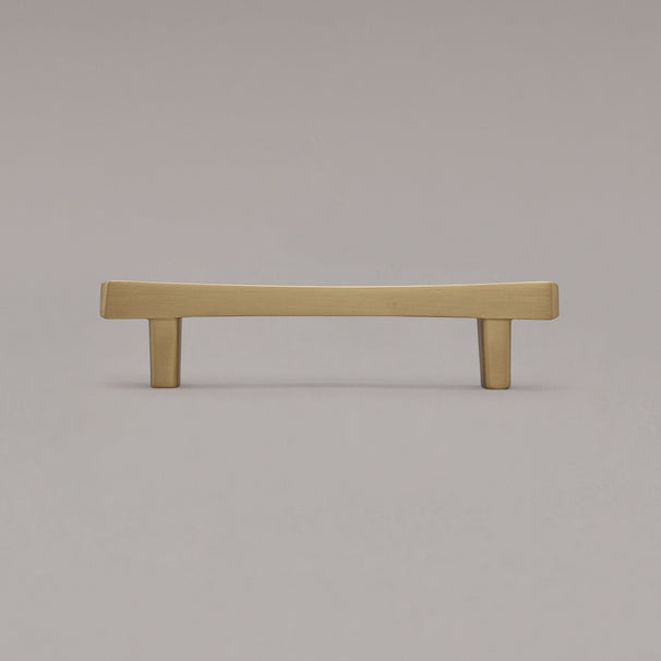 satin brass gold diamond cabinet pull standing on gray background