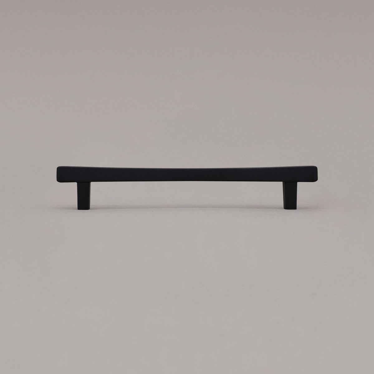 Medium matte black diamond cabinet pull standing on gray background
