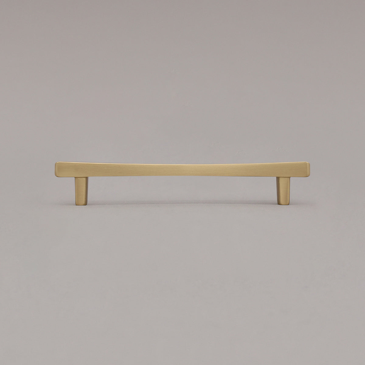 Medium satin brass gold diamond cabinet pull standing on gray background