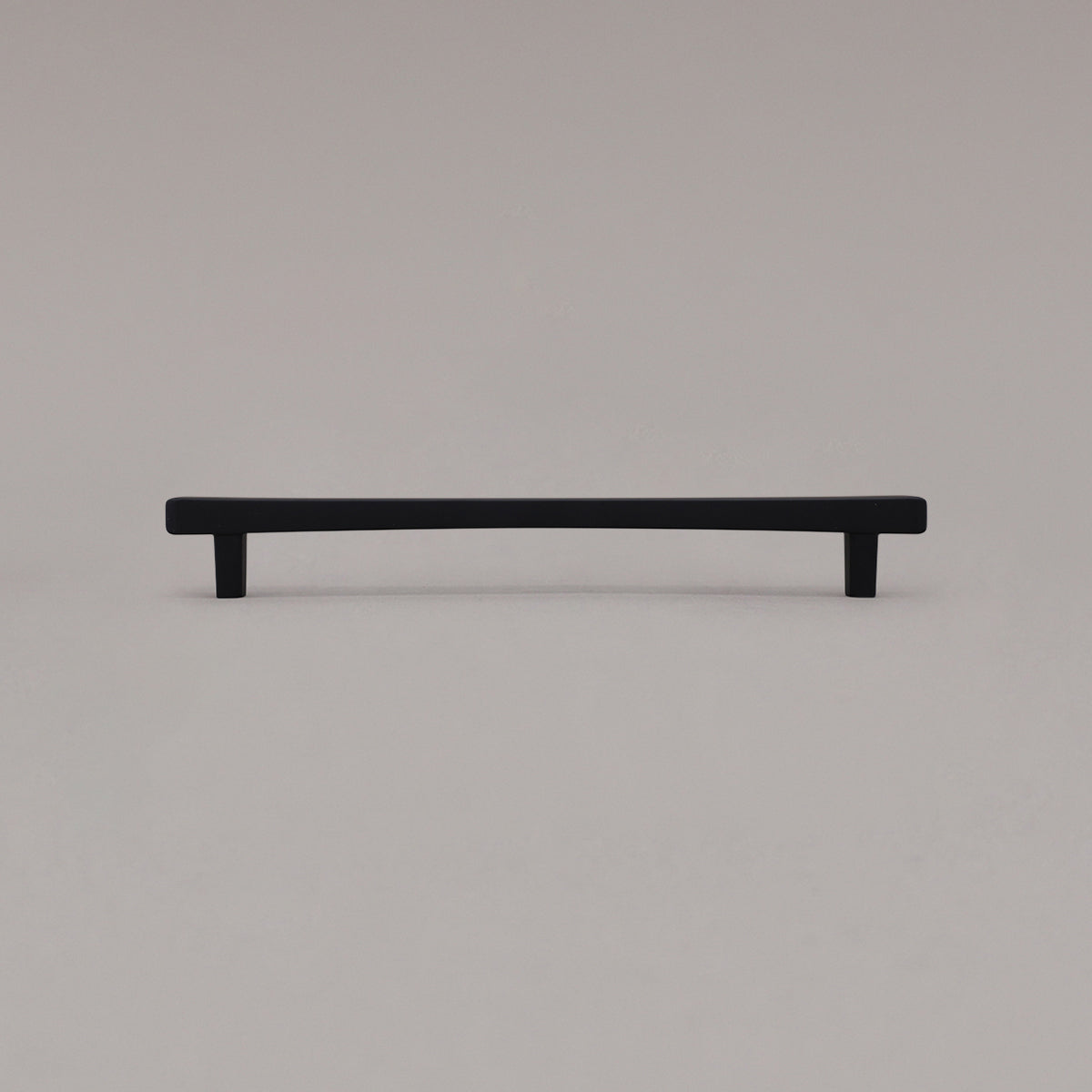 Large matte black diamond cabinet pull standing on gray background