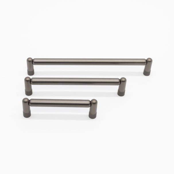 three sizes of graphite knurled cabinet pulls on white background