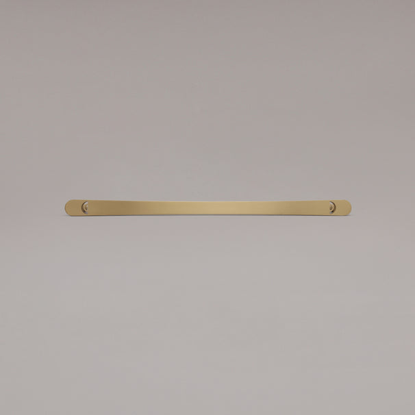 18" Horizon appliance pull in Satin Brass laying on gray background