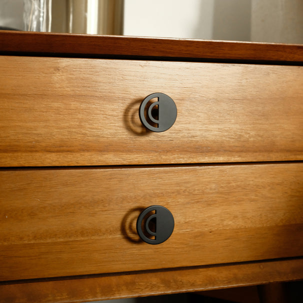 Horizon matte black knobs installed on wooden bedside table