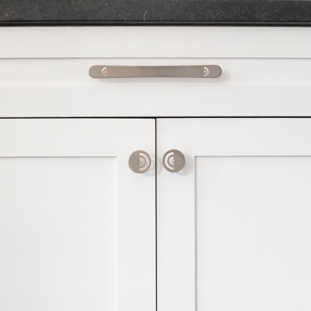 horizon satin nickel pull and knob installed on white cabinet