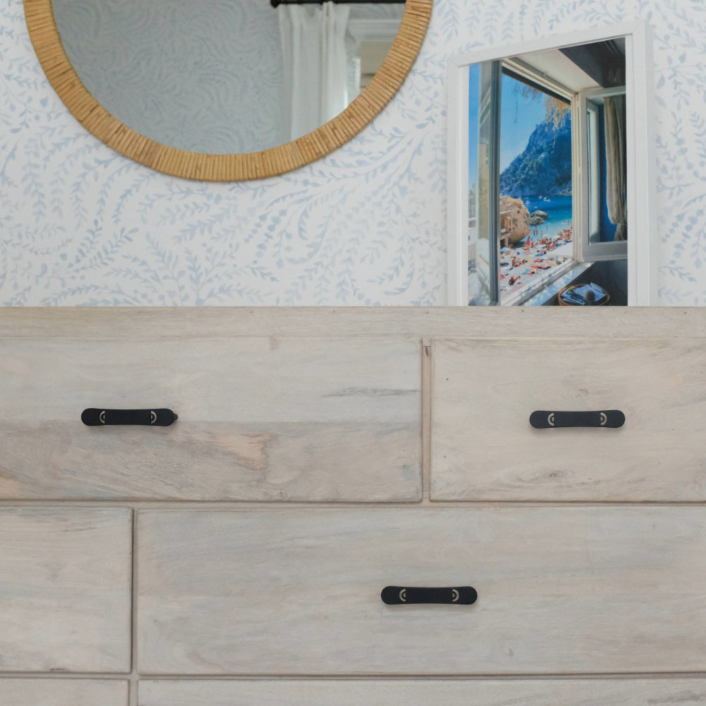 Horizon matte black pulls installed on a light wood dresser