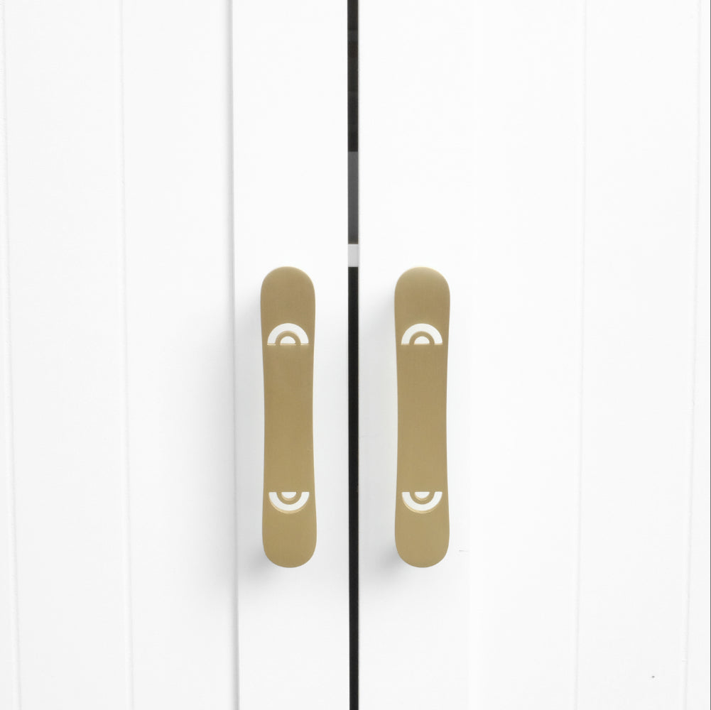 horizon satin brass gold cabinet pulls installed on white cabinets