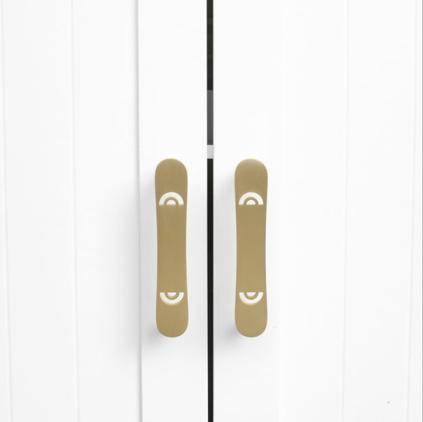 horizon satin brass gold cabinet pulls installed on white cabinets