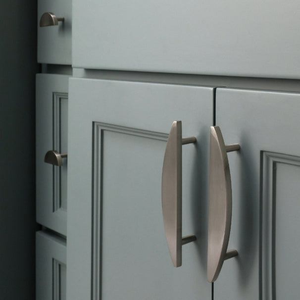 Satin nickel half moon cabinet pulls and cabinet knobs installed on blue cabinets