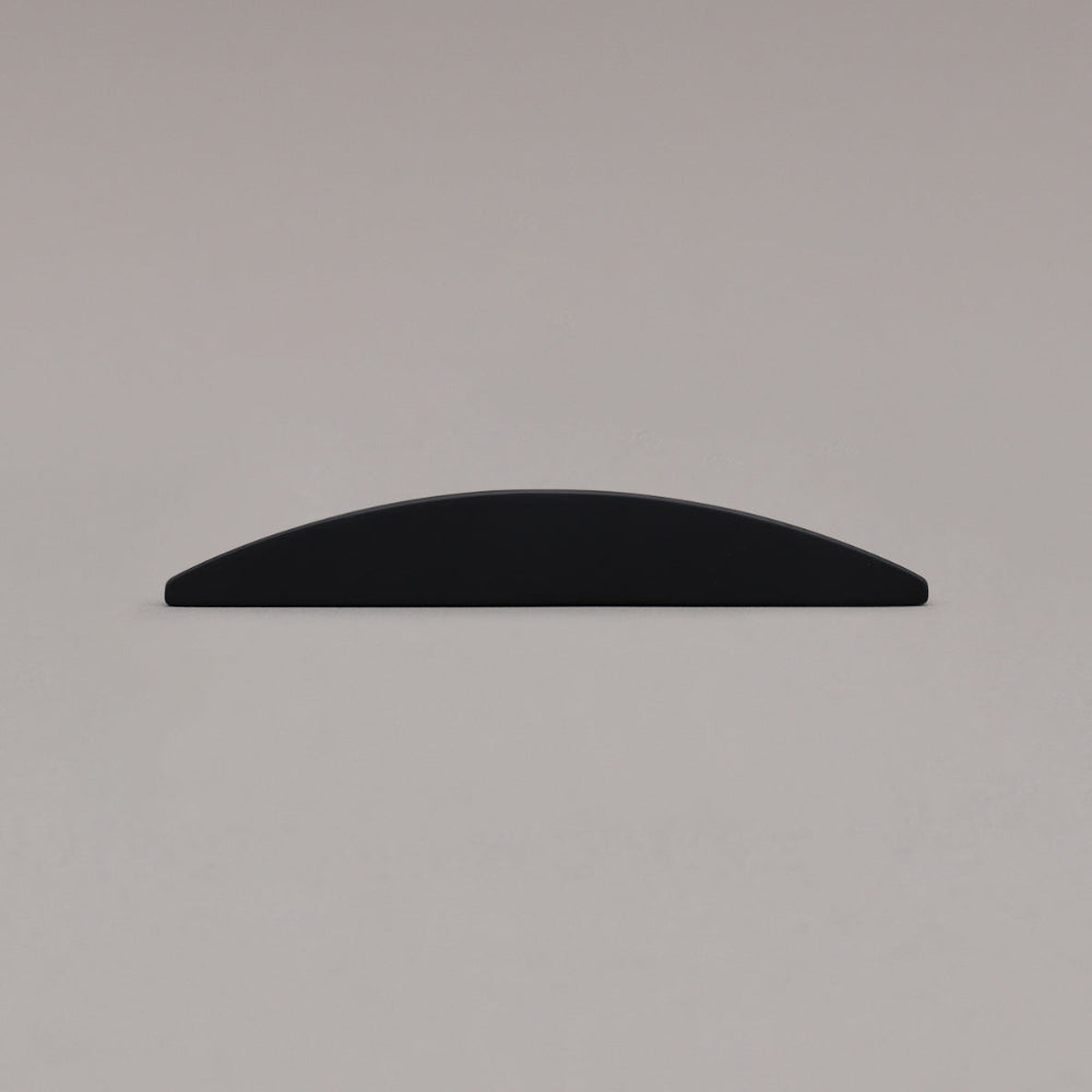 small matte black half moon pull laying on gray background