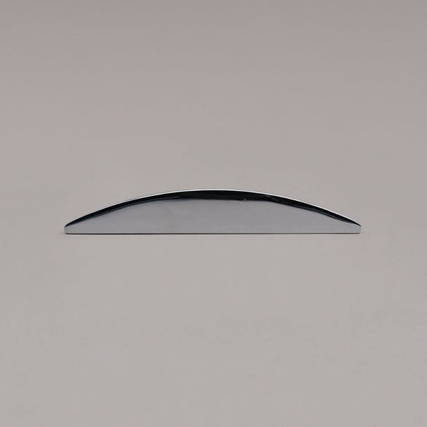 small polished chrome half moon pull laying on gray background