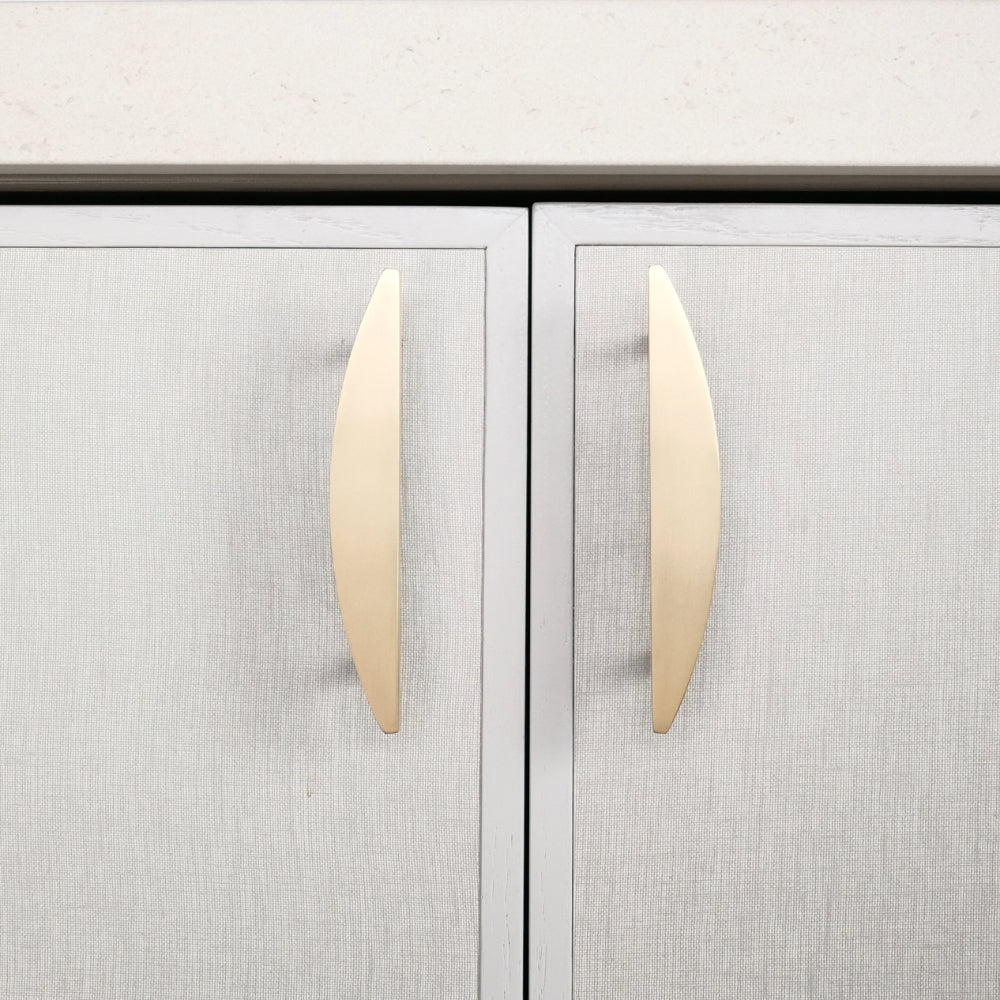 half moon satin brass gold pulls installed on neutral cabinets