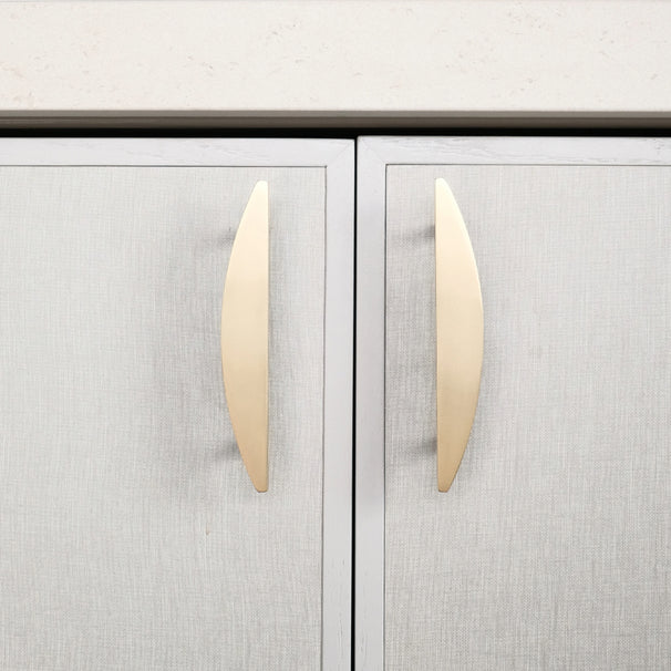 half moon satin brass gold pulls installed on neutral cabinets