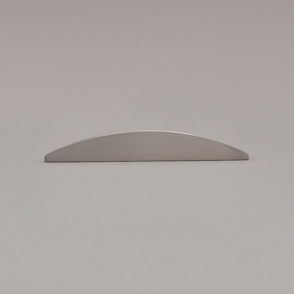 small satin nickel half moon pull laying on gray background