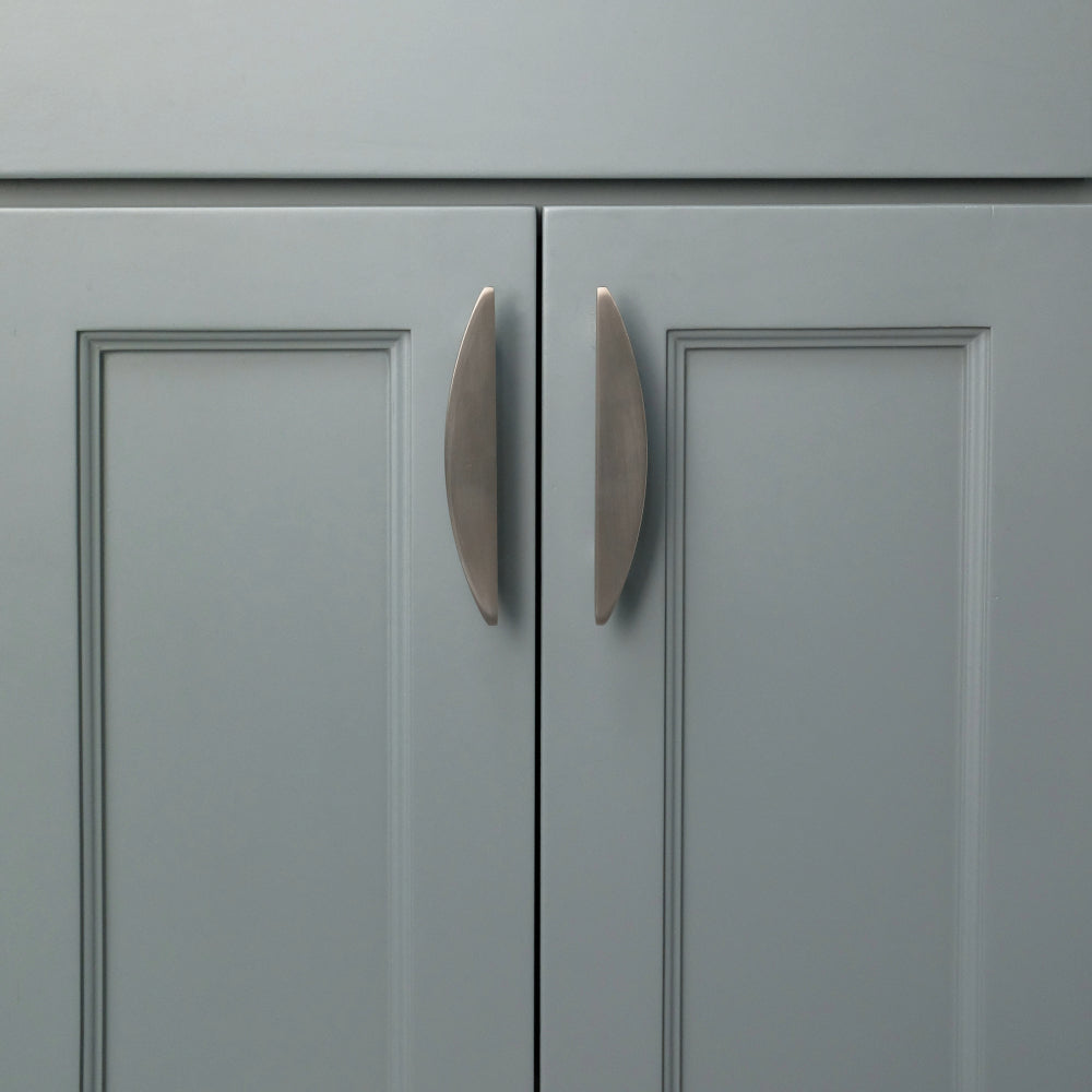 Satin nickel half moon cabinet pulls installed on blue cabinets
