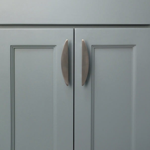 Satin nickel half moon cabinet pulls installed on blue cabinets