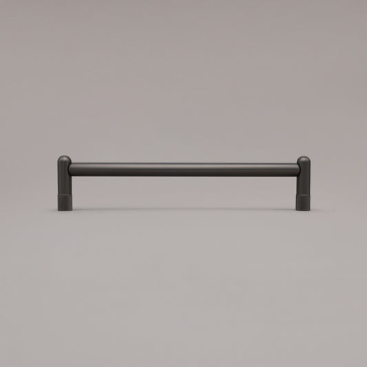 12" knurled appliance pull in aged brass standing on gray background