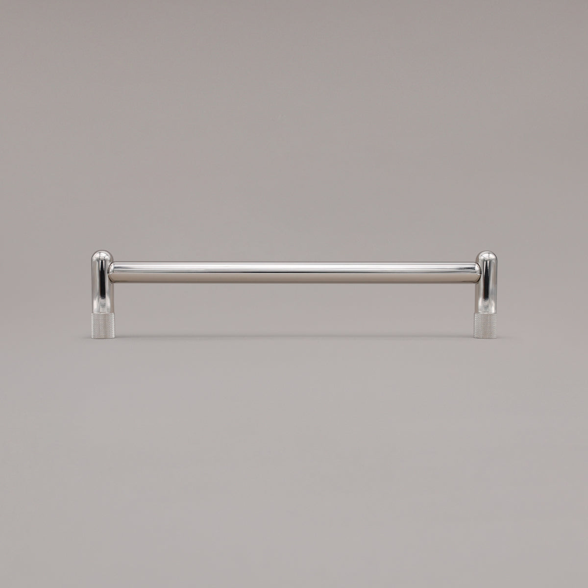 12" knurled appliance pull in polished nickel standing on gray background