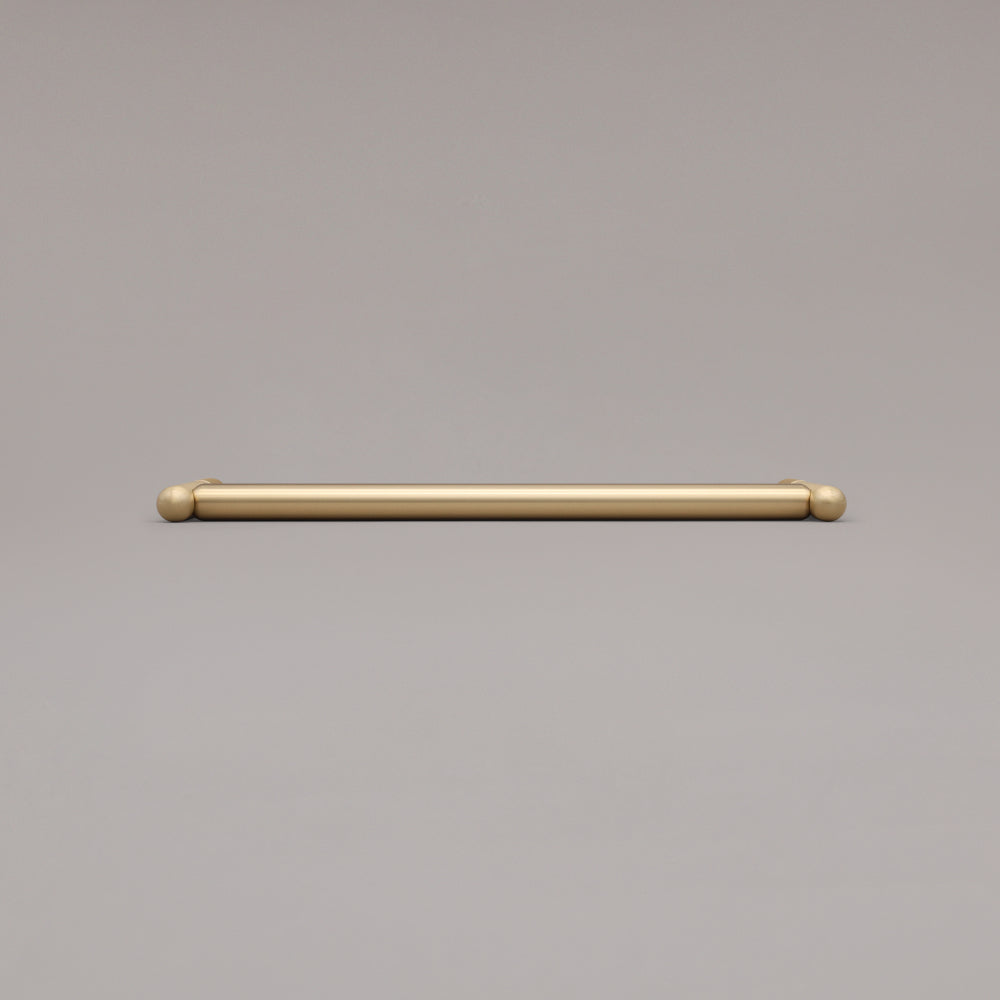 12" Knurled appliance pull in Satin Brass laying on gray background
