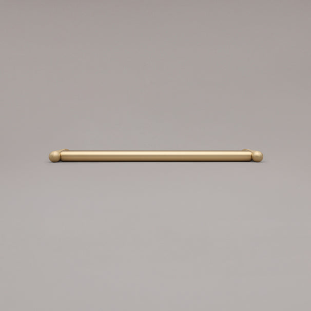 12" Knurled appliance pull in Satin Brass laying on gray background