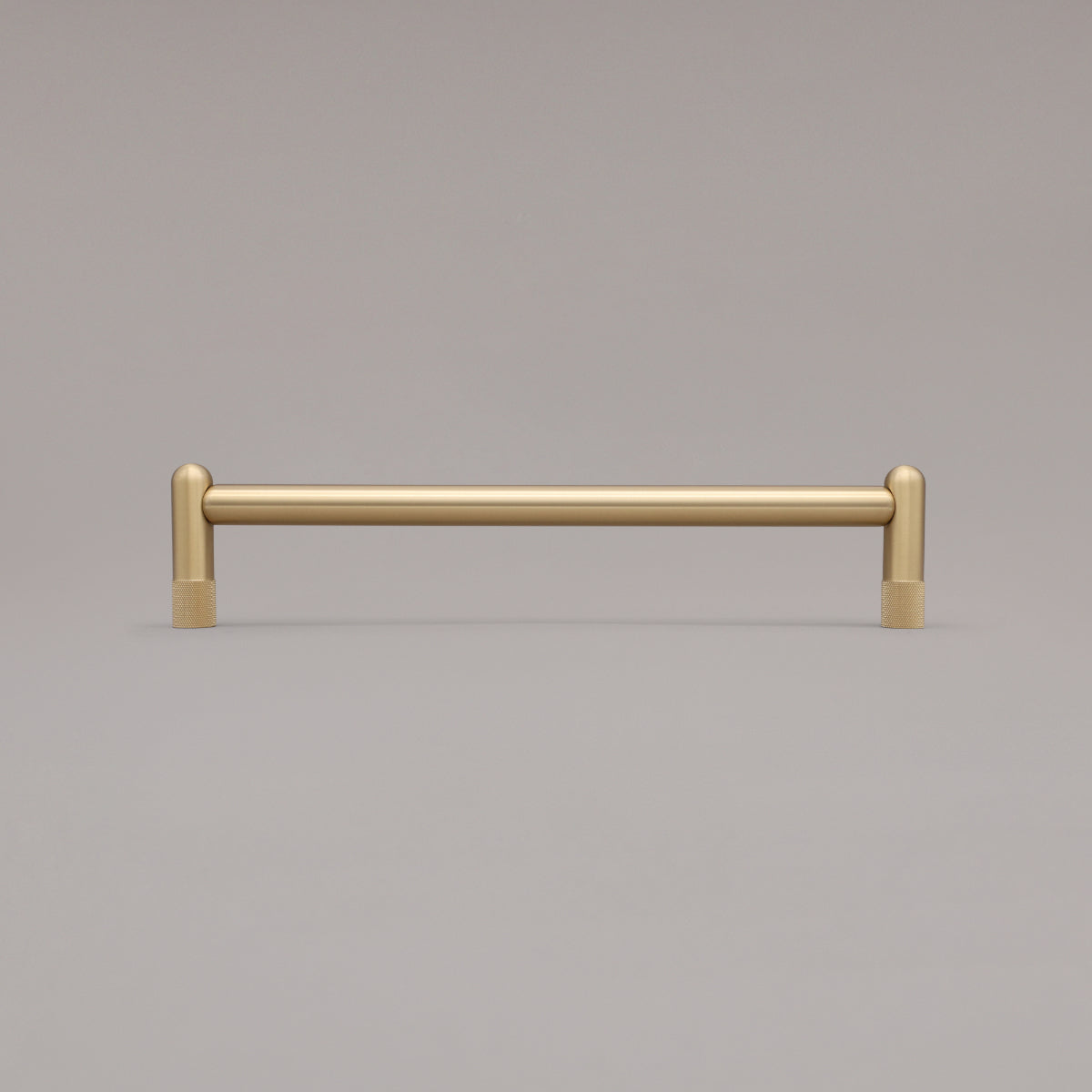 12" knurled appliance pull in satin brass standing on gray background