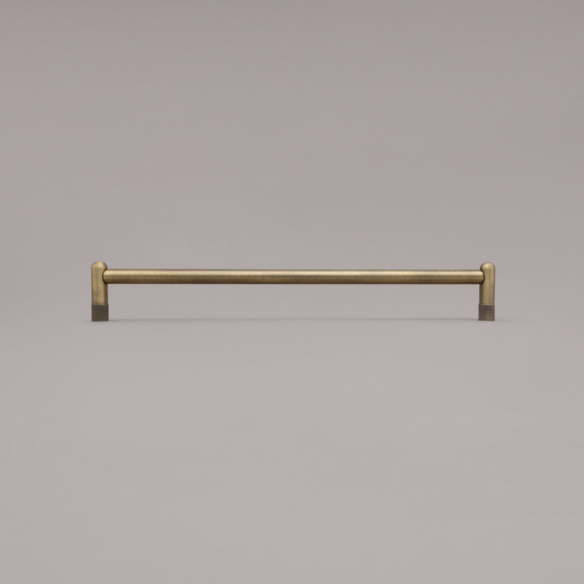 18" knurled appliance pull in aged brass standing on gray background