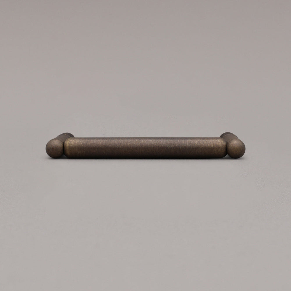 Knurled antique english pull laying down on gray background