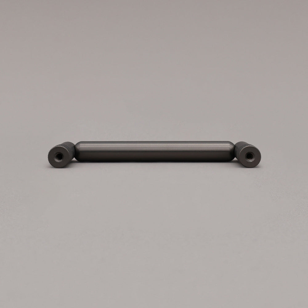 rear view of knurled graphite pull on gray background