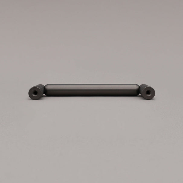 rear view of knurled graphite pull on gray background
