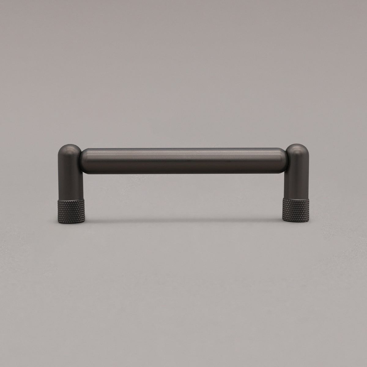 standing knurled graphite cabinet pull on gray background