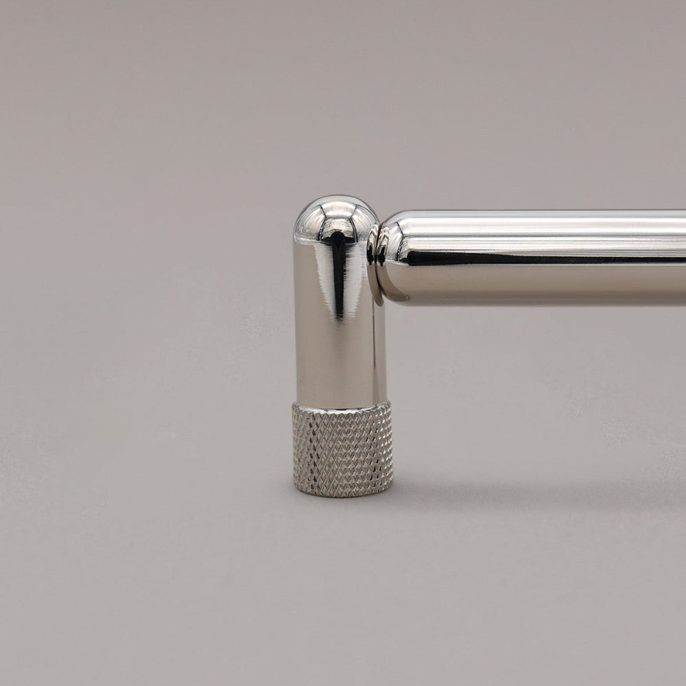 close up of knurled polished nickel stem on gray background