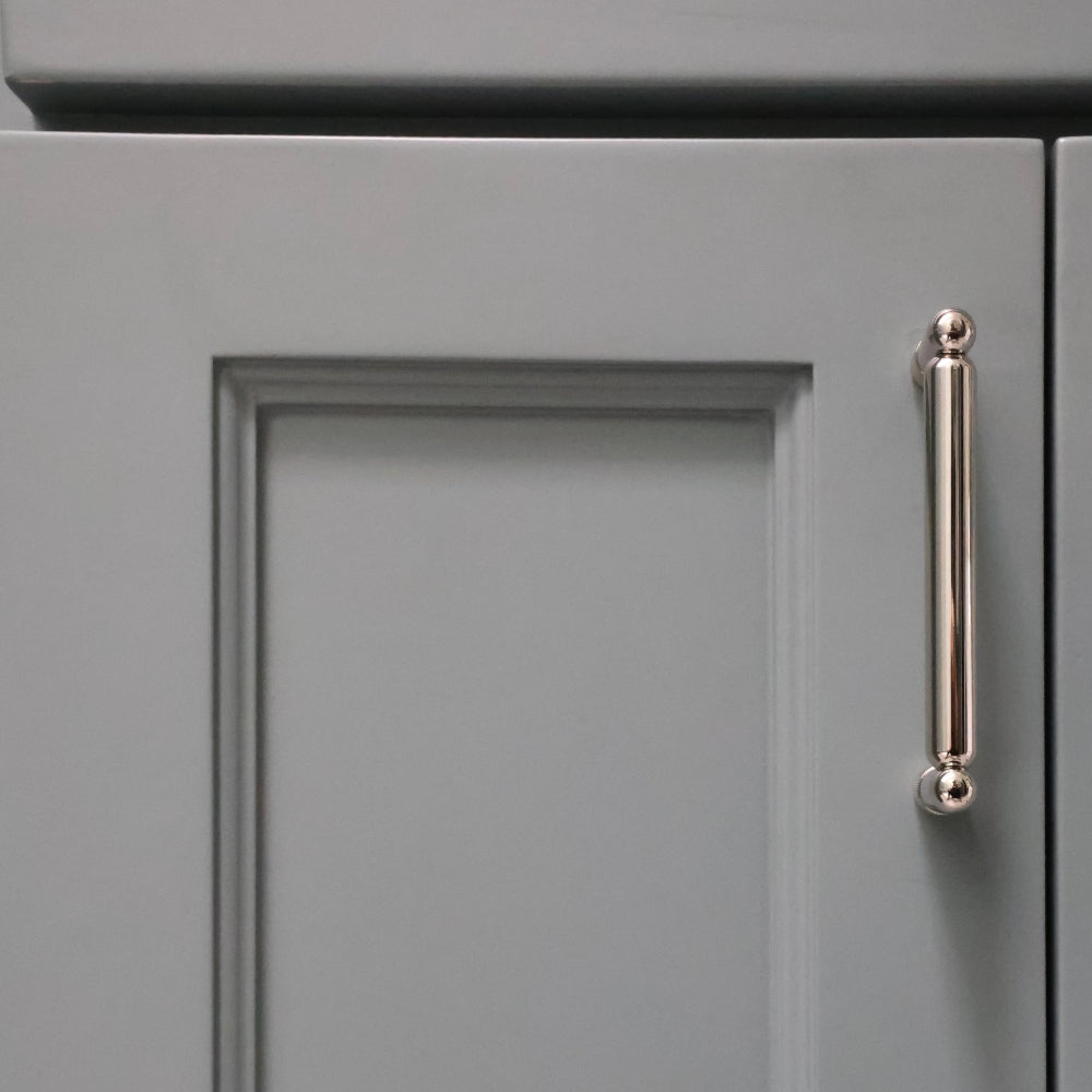 knurled polished nickel pull installed on blue bathroom cabinet door