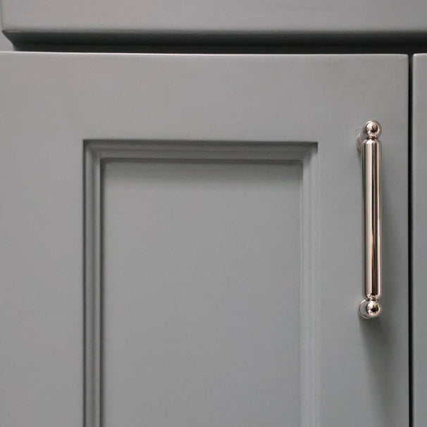 knurled polished nickel pull installed on blue bathroom cabinet door