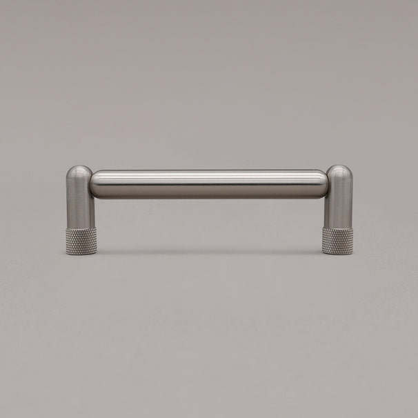 standing knurled satin nickel silver cabinet pull on gray background