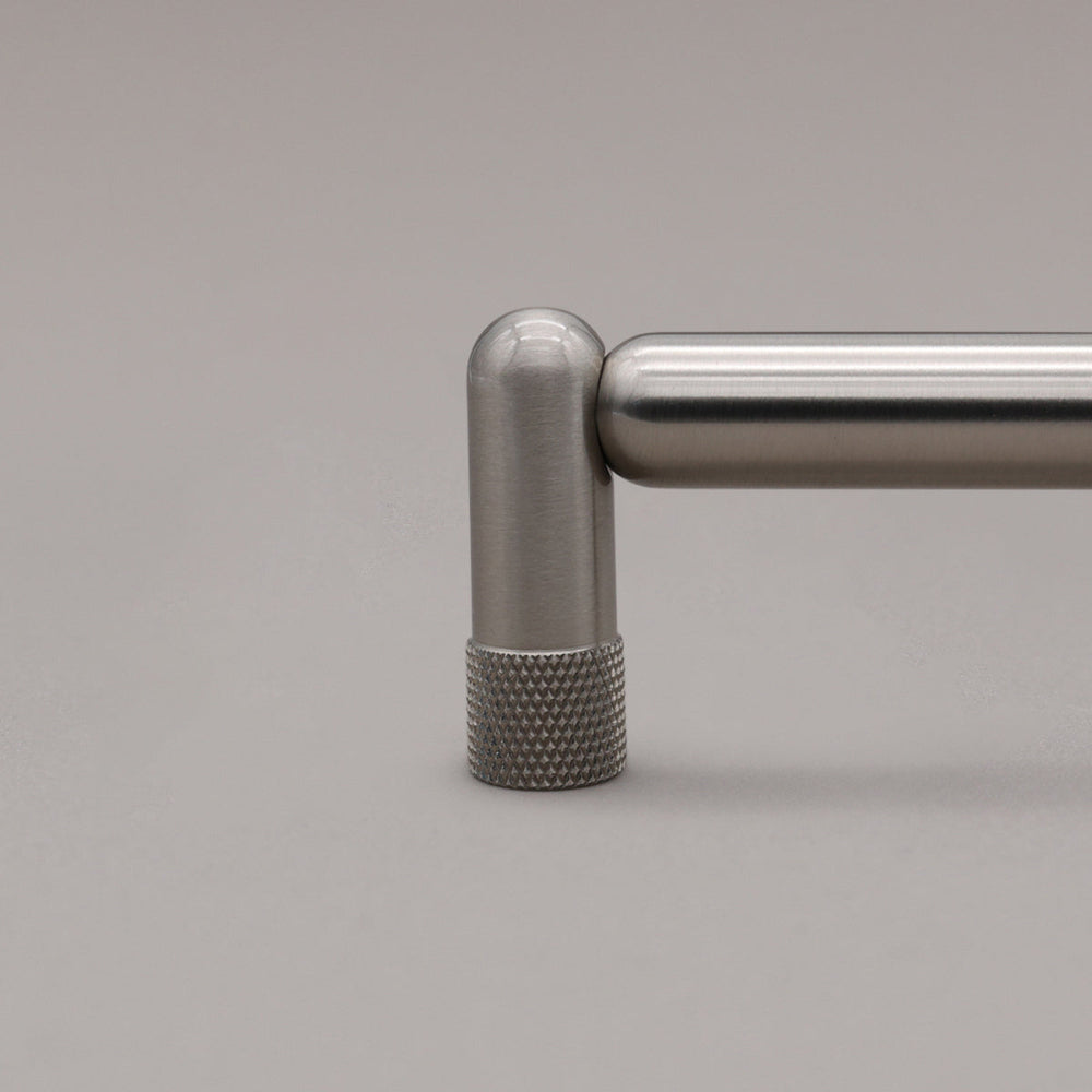 close up of knurled satin nickel silver pull stem on gray background