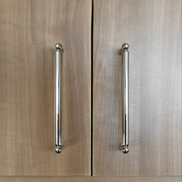 knurled polished nickel pulls installed on wooden kitchen cabinet doors