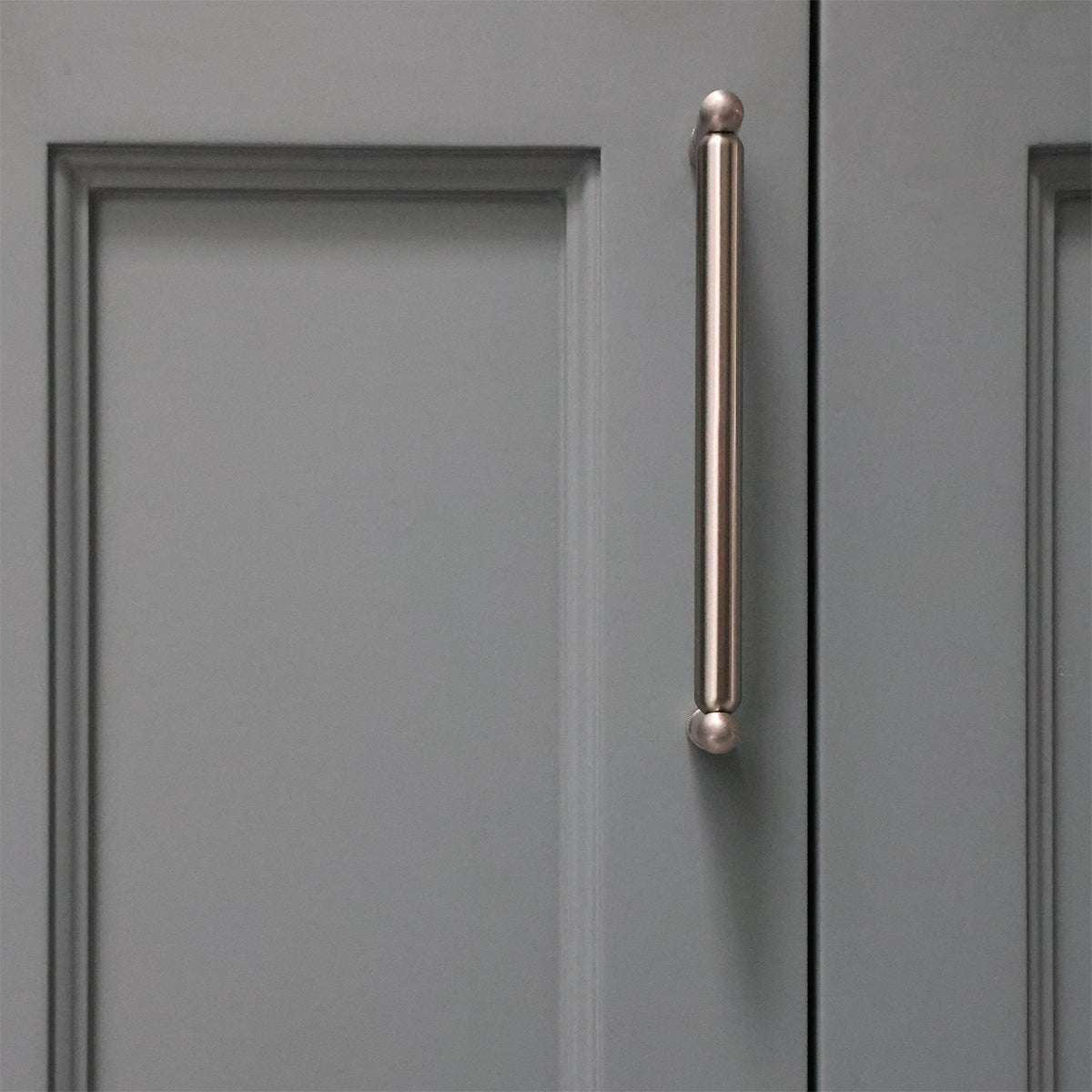 Gray cabinet door with a bronze handle