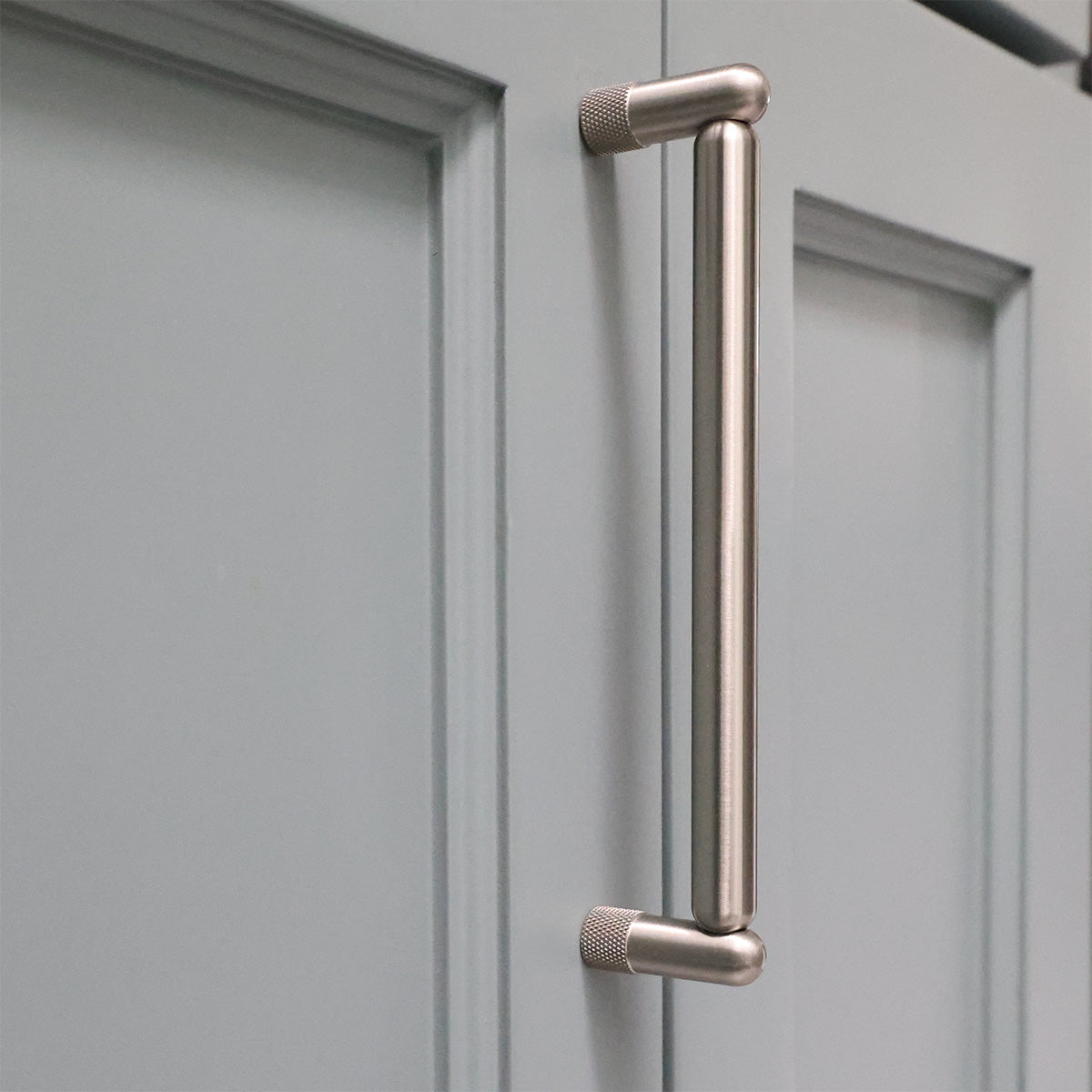 Metal handle on a gray cabinet door