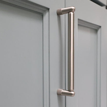 Metal handle on a gray cabinet door