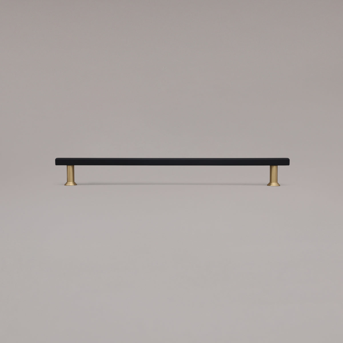 18" Mod appliance pull in Black and Satin Brass standing on gray background