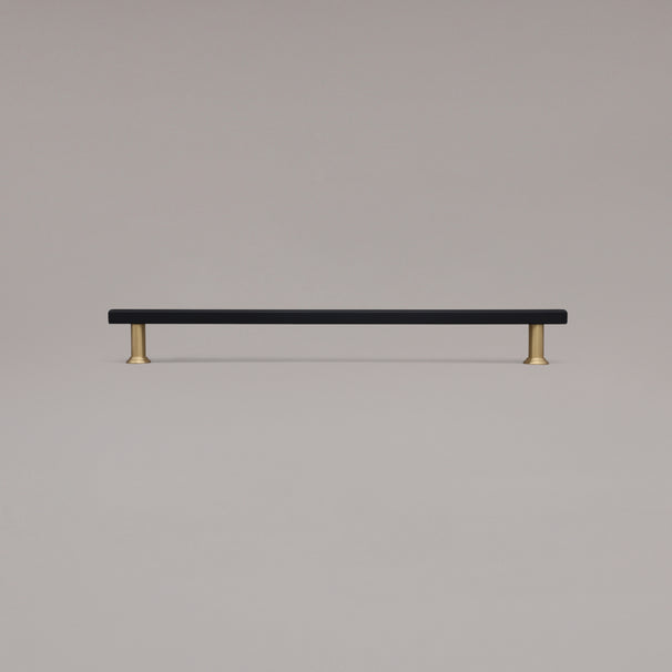 18" Mod appliance pull in Black and Satin Brass standing on gray background