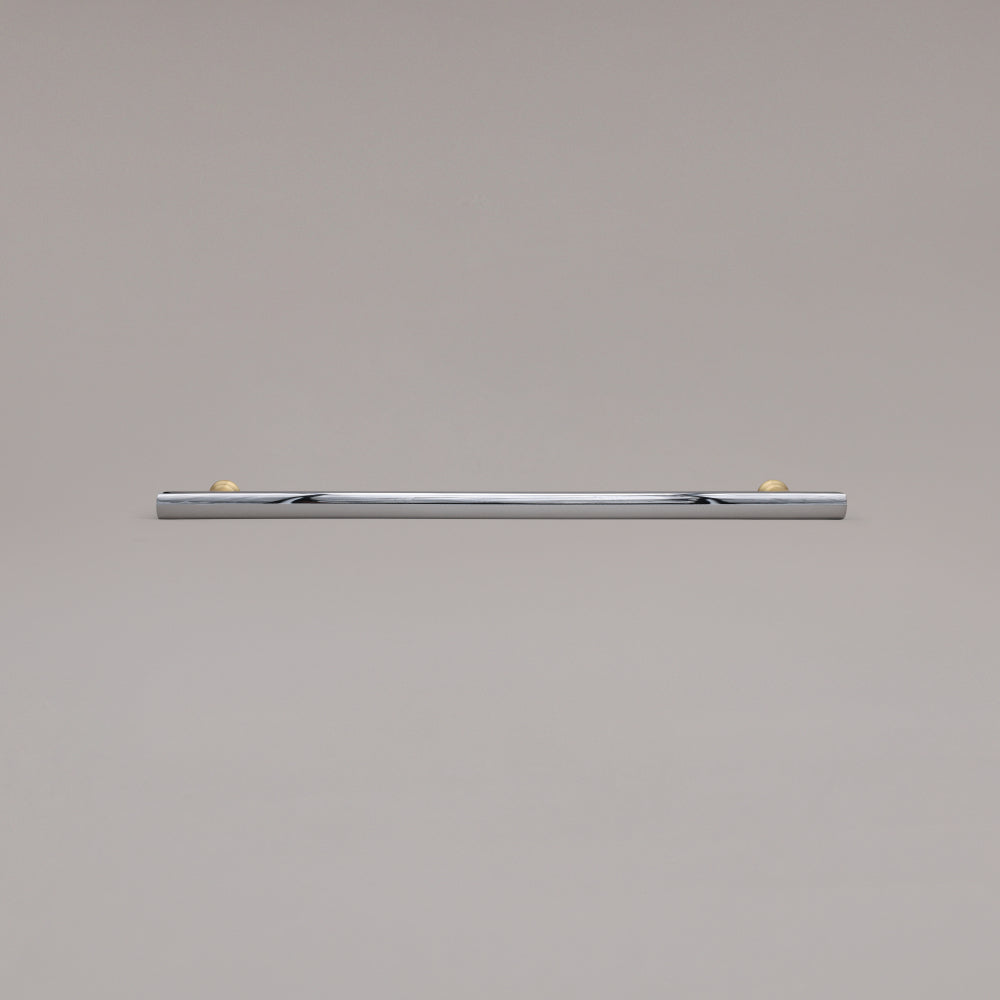 18" Mod appliance pull in Polished Chrome and Satin Brass laying on gray background